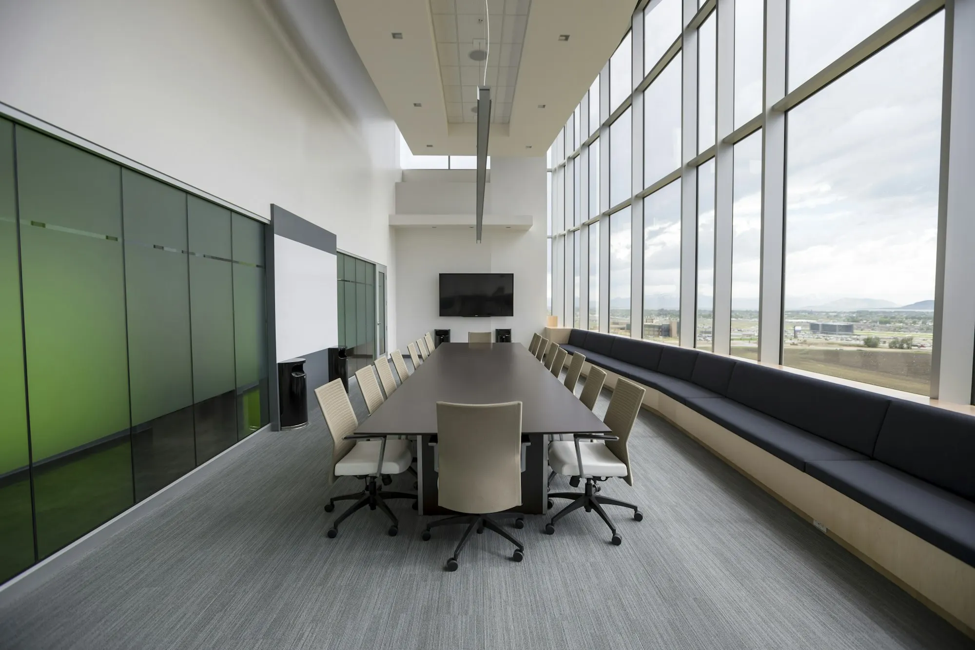 Long meeting table with a screen at the end (illustrative)