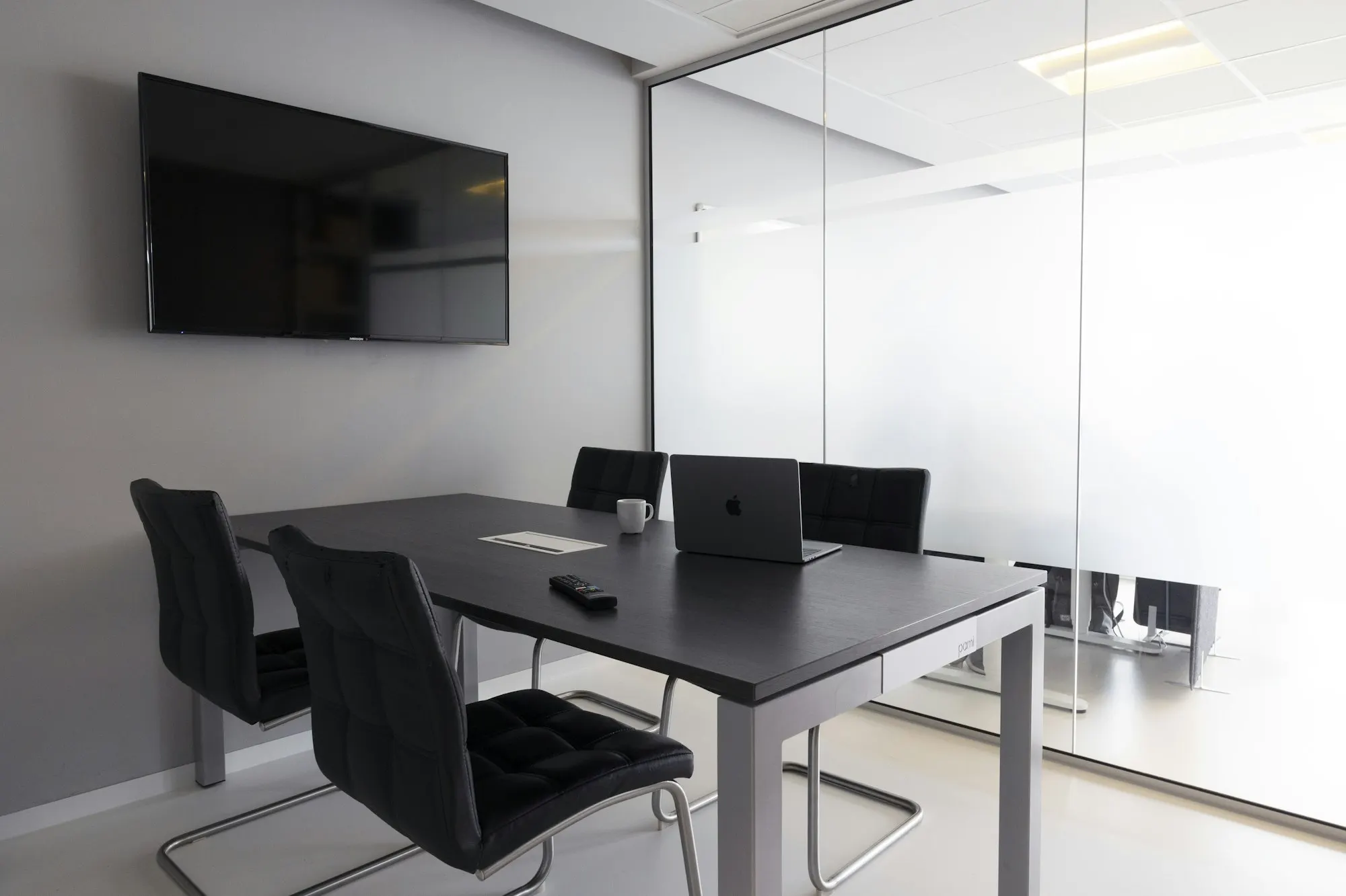 Small meeting room with a wall screen (illustrative)