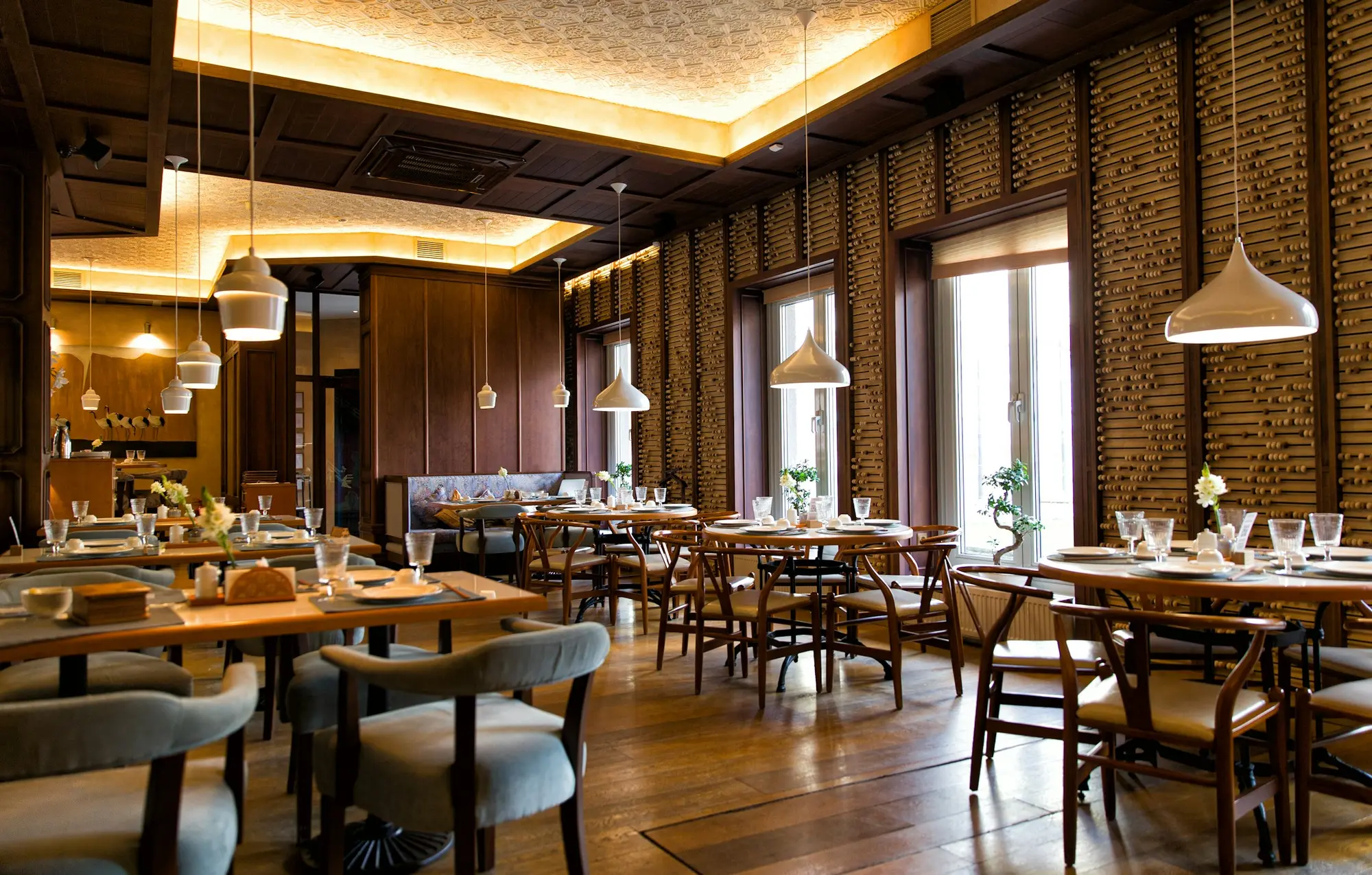 Warmly lit restaurant with set tables (illustrative)